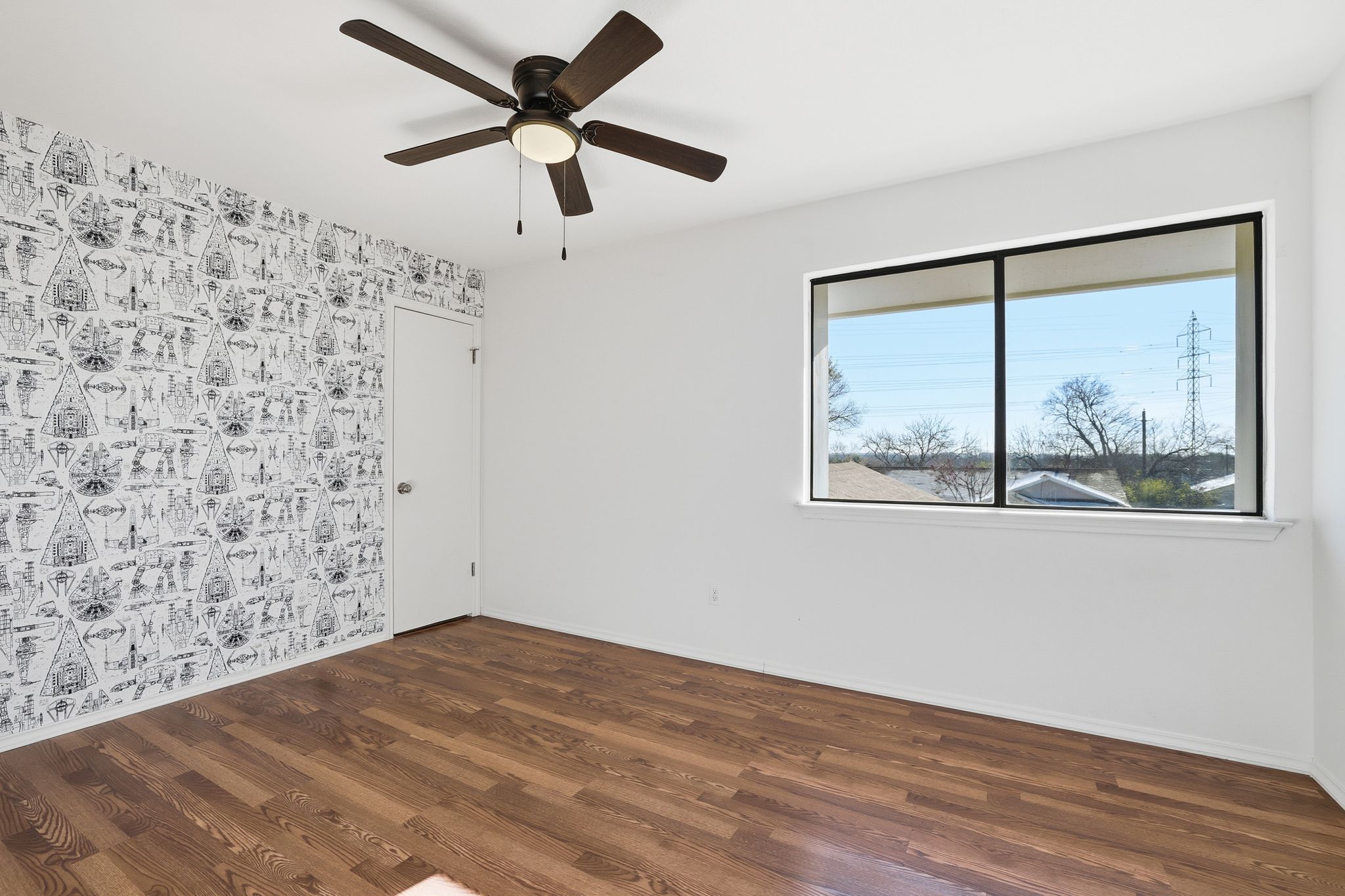 13004 Esplanade Street Austin, TX 78727 - Photo 14 of 36 Additional bedroom with accent wall, ceiling fan, wood flooring, and walk-in closet.