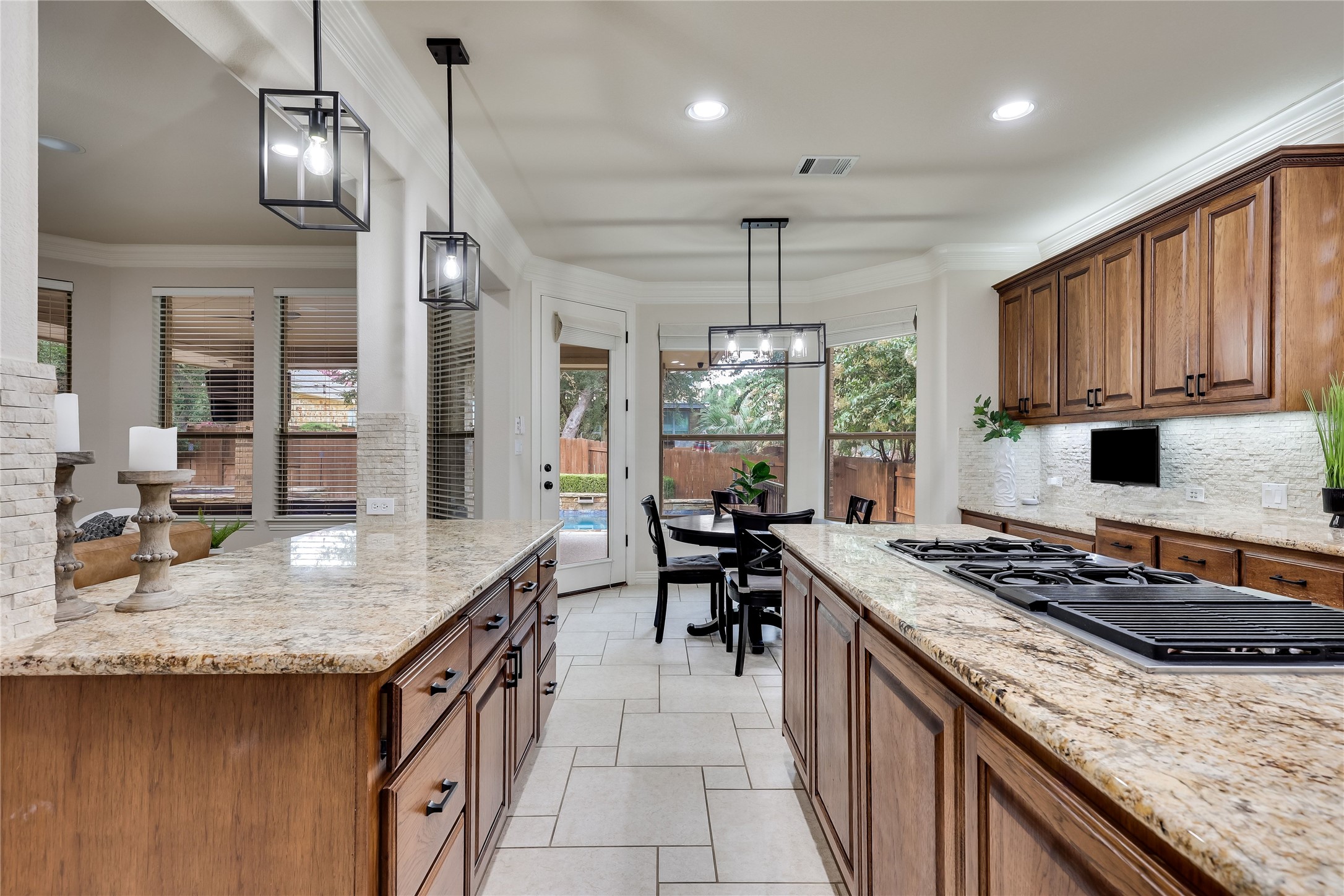 408 Ridgetop Bend Cedar Park, TX 78613 - Photo 14 of 40 Culinary aspirations find their home in this well-appointed kitchen, offering ample space and direct outdoor access.
