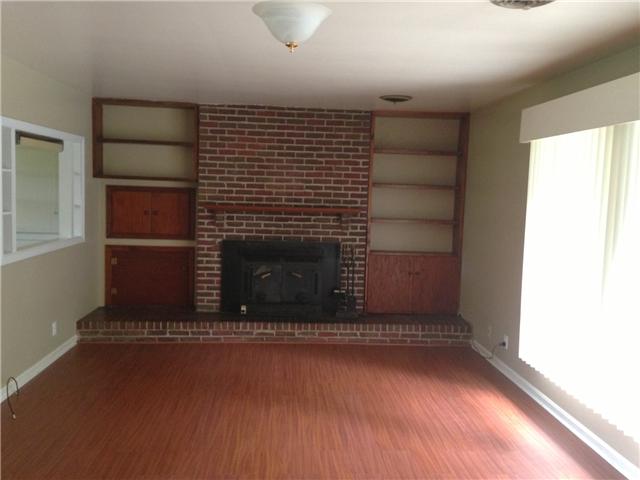 4618 Marion Road Cunningham, TN 37052 - Photo 4 of 16 Brick fireplace with insert. Custom book shelves on each side.