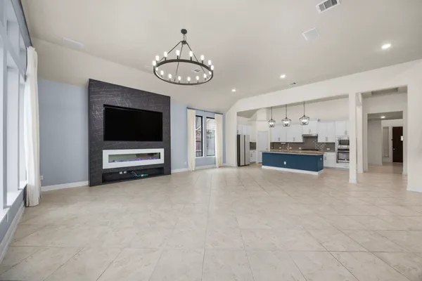 a view of kitchen with furniture and a flat screen tv