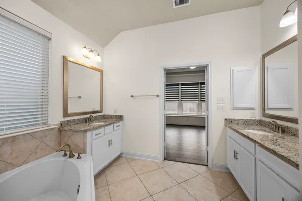 a bathroom with a granite countertop sink a vanity and a mirror
