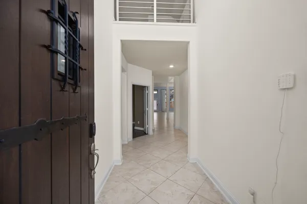 a view of a hallway with wooden shelves