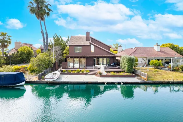 a view of a house with swimming pool and a yard