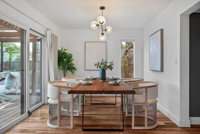 a view of a dining room with furniture wooden floor and chandelier