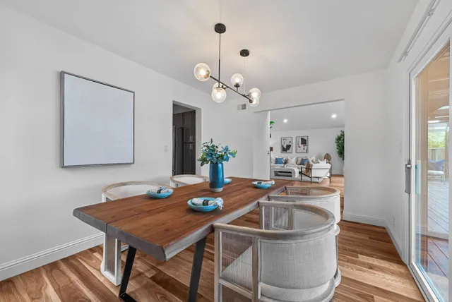 a dining room with furniture and wooden floor