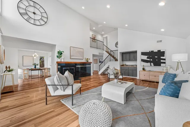 a living room with furniture a table and a fireplace