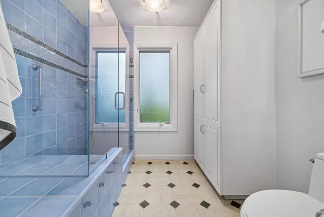 a bathroom with a shower toilet and sink