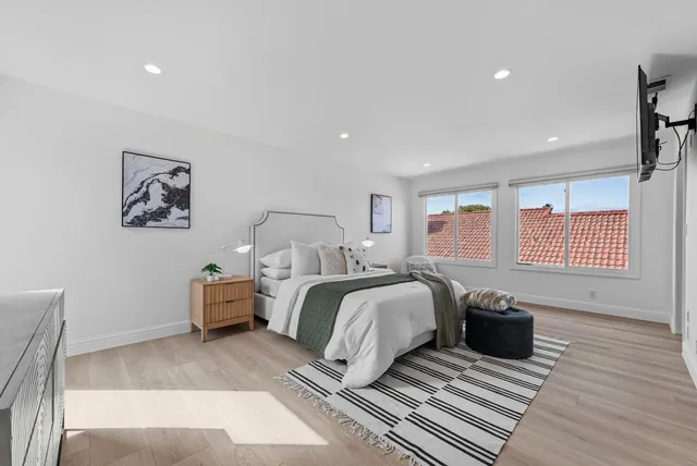 a spacious bedroom with two beds and a large window