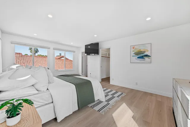 a spacious bedroom with a bed and a couch