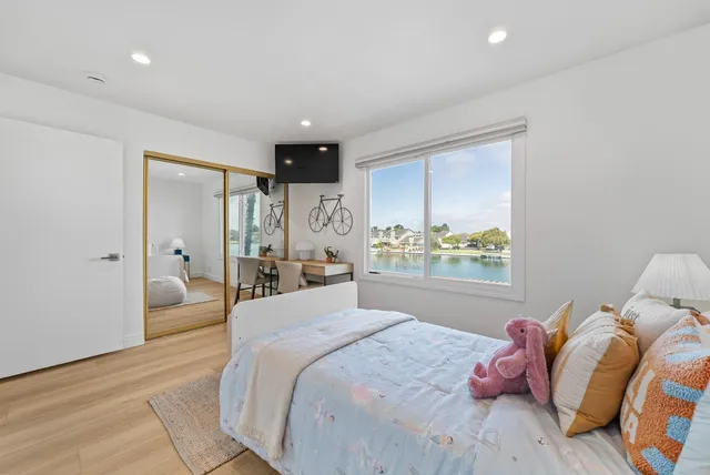 a bedroom with a bed and a large window