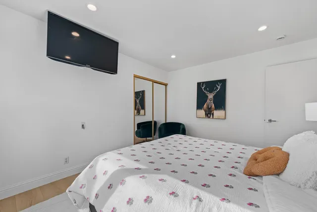 a bedroom with a large bed and a window