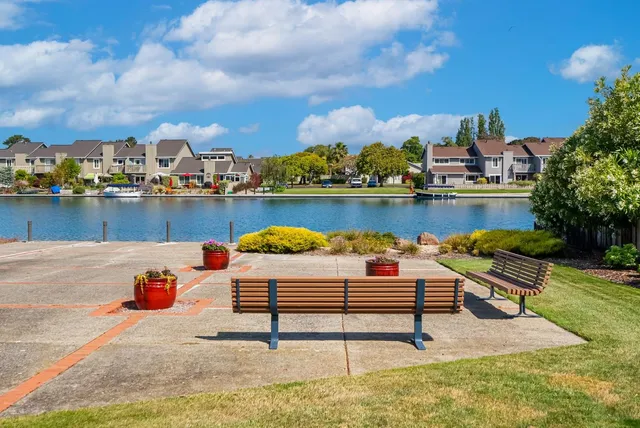 a view of a lake with houses in the back