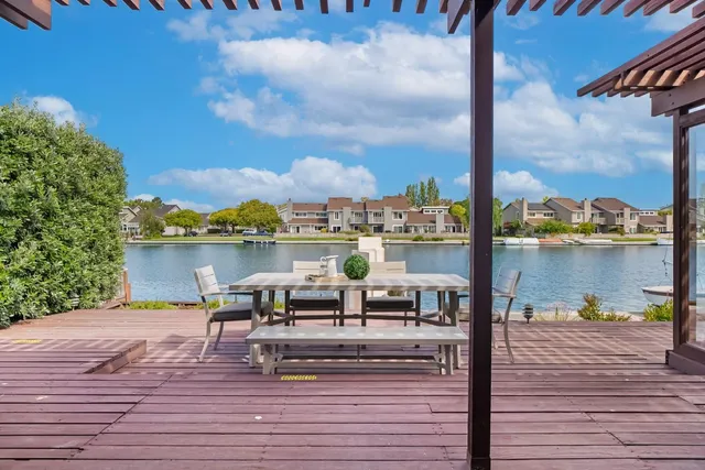 a view of a balcony with wooden floor and outdoor seating