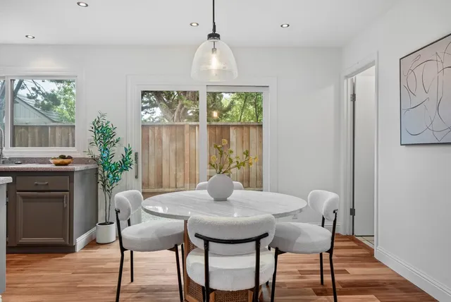 a view of a dining room with furniture window and wooden floor