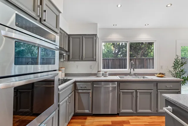 a kitchen with stainless steel appliances granite countertop a sink and stove