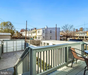 a view of a balcony with wooden floor and fence