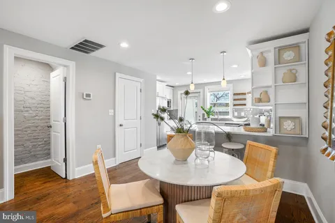 a dining room with furniture and wooden floor