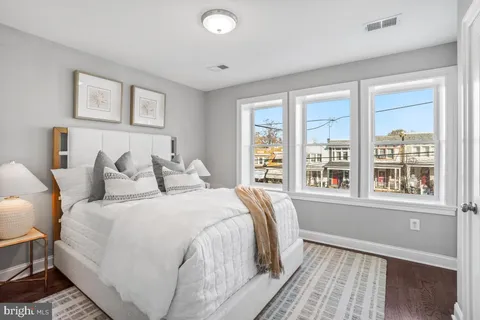a bedroom with a large bed and a window