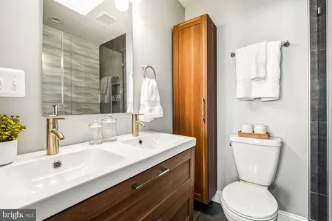 a bathroom with a sink a toilet and shower curtain