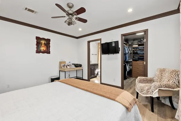 a bedroom with a bed and a refrigerator