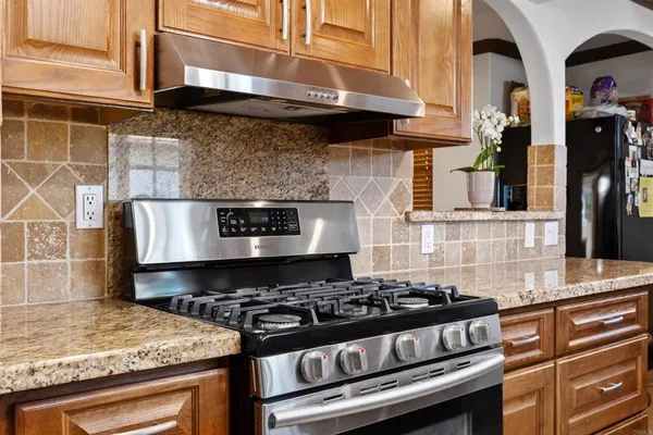 a stove top oven sitting inside of a kitchen