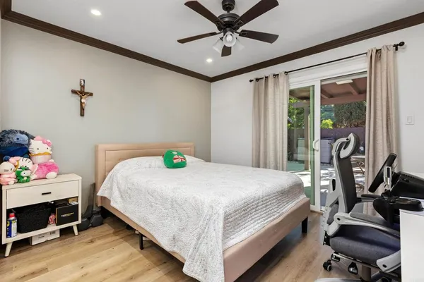 a bedroom with a bed and a chandelier