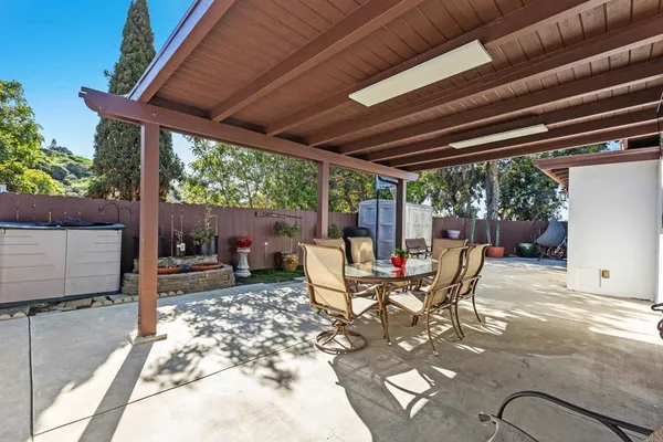 a view of a patio with table and chairs next to a yard