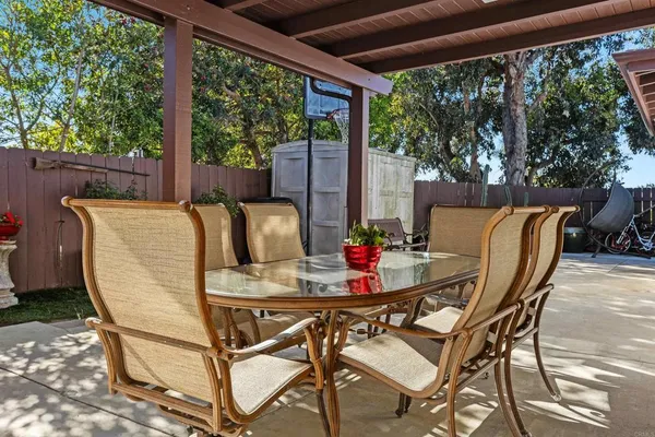a view of an outdoor dining space with furniture and wooden floor