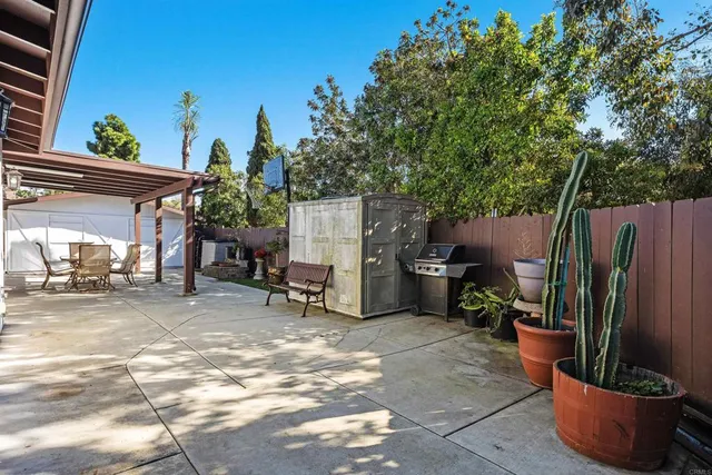 a view of a backyard with furniture and plants