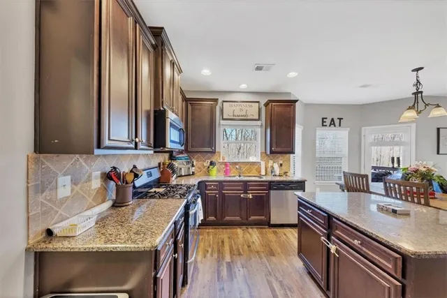 a kitchen with lots of counter top space and wooden floor