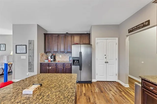a kitchen with refrigerator cabinets and wooden floor