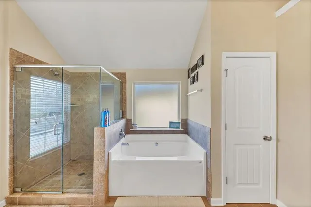 a bathroom with a bathtub and a shower