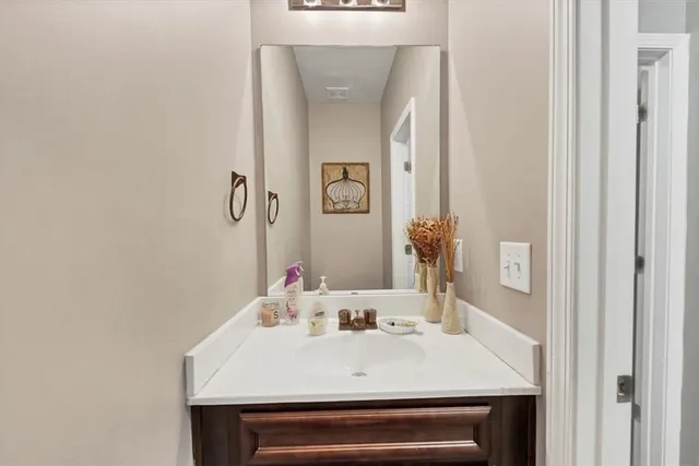 a bathroom with a sink vanity and a mirror