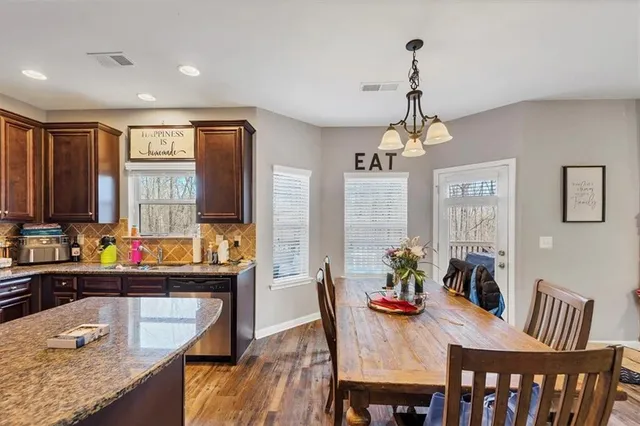 a dining room with furniture a chandelier and window