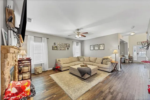 a living room with furniture and a wooden floor