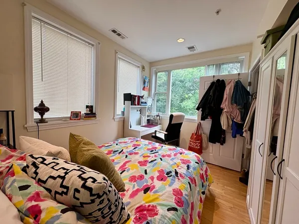 a bedroom with bed and glass door