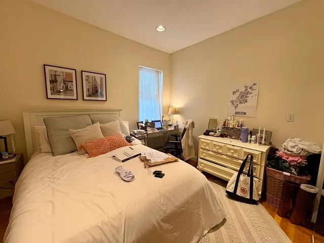 a bed room with a bed and wooden floor