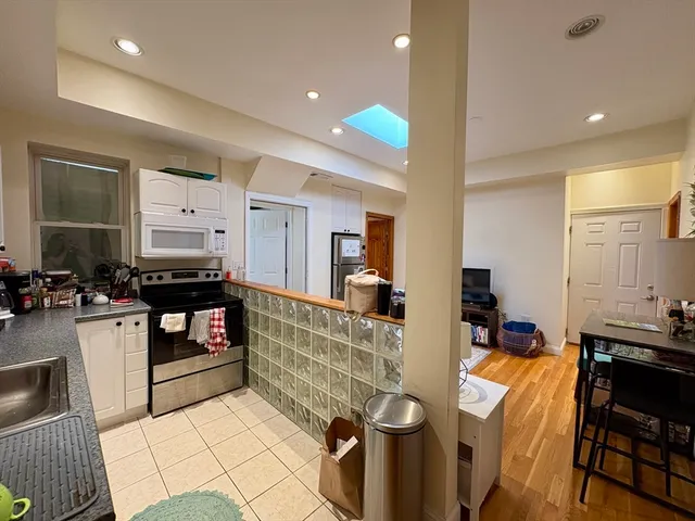 a kitchen with sink refrigerator and cabinets