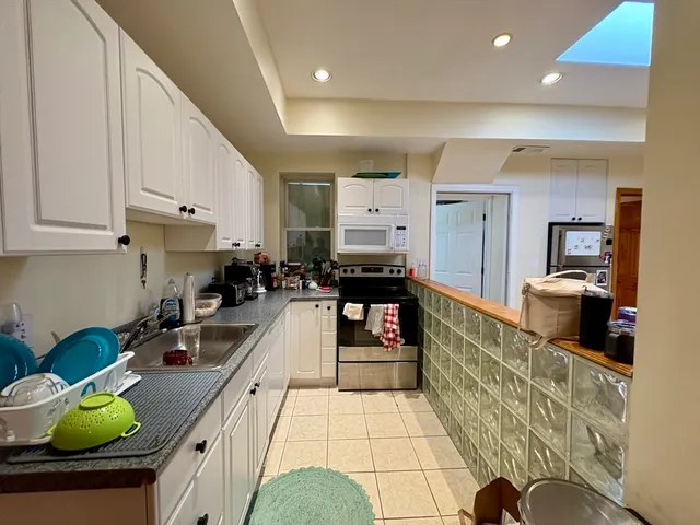 a kitchen with stainless steel appliances granite countertop a sink dishwasher stove and cabinets