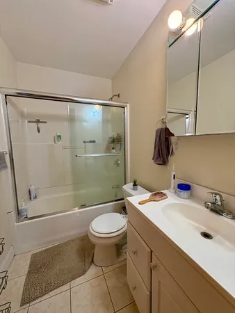 a bathroom with a sink mirror toilet and shower