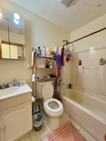 a bathroom with a sink toilet vanity and shower
