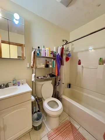 a bathroom with a sink toilet vanity and shower