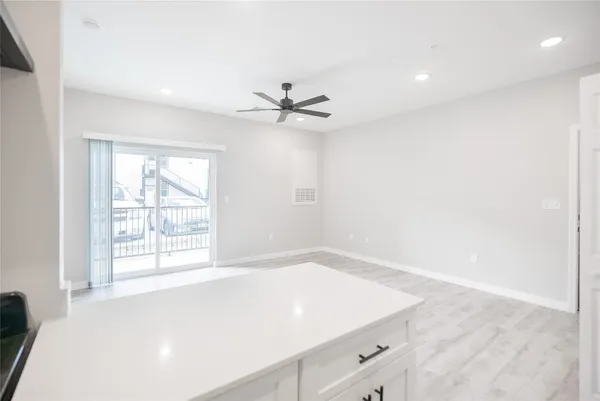 a view of a hallway with a white cabinet and a door