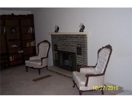 Living Room. Brick Fireplace is the focal point of the Living Room