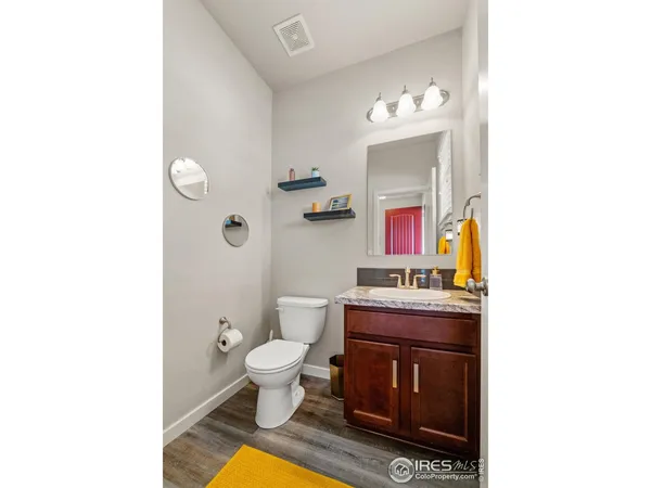 a bathroom with a toilet a sink and a mirror
