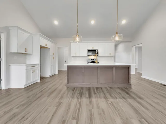 a large kitchen with kitchen island a island in the center