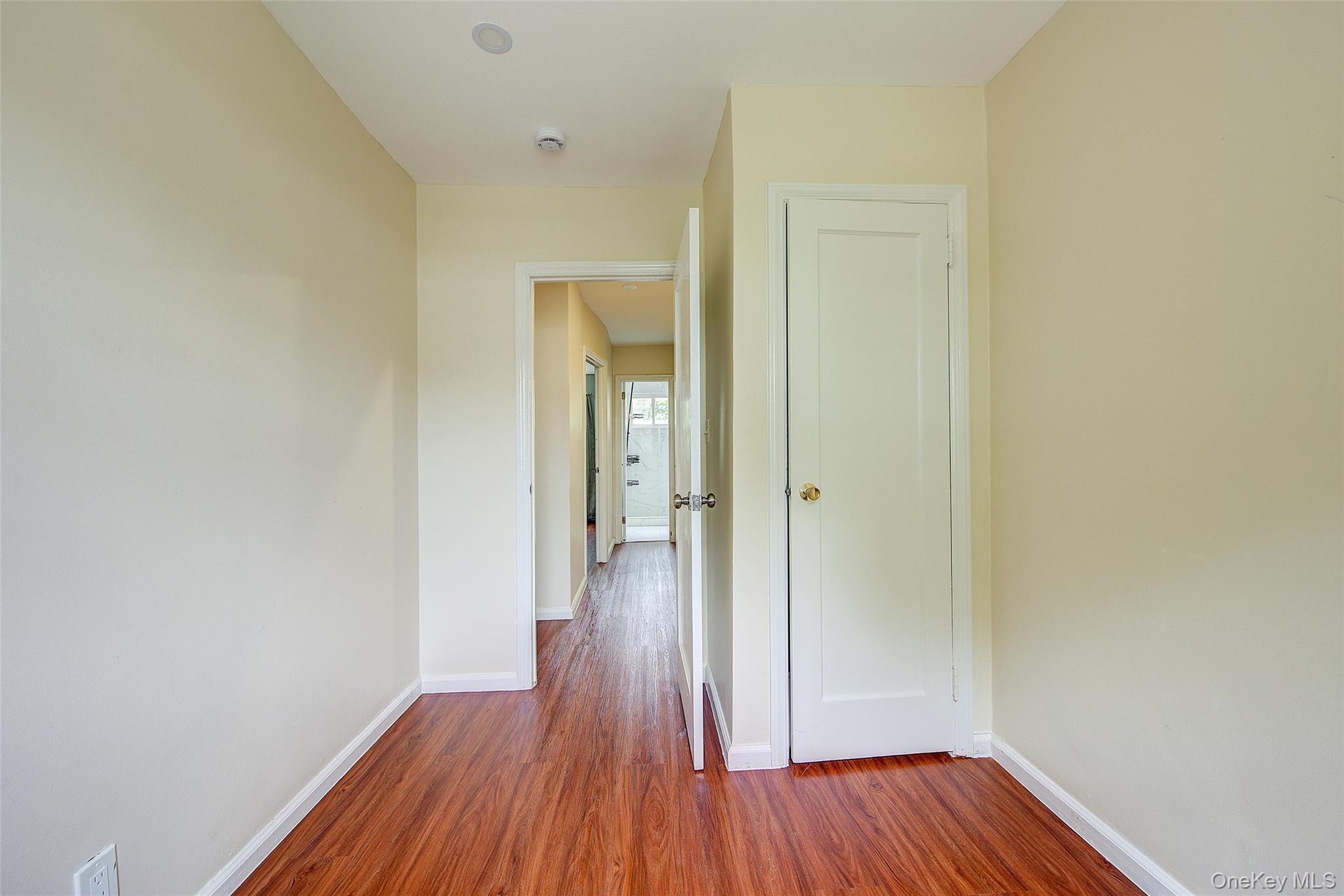 164-38 76th Road Queens, NY 11366 - Photo 22 of 44 a view of a hallway with wooden floor
