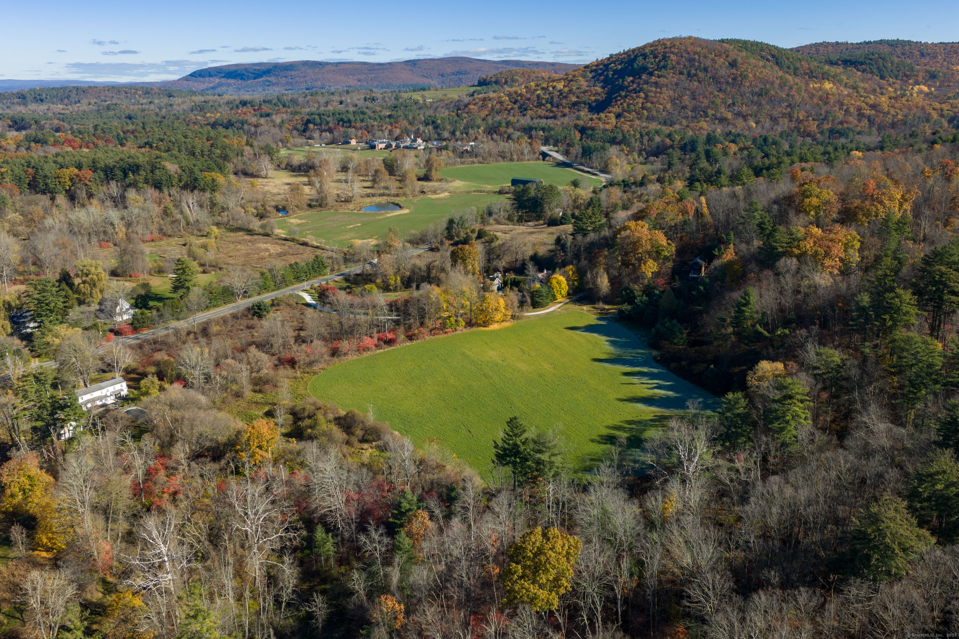 0 Lime Rock Road Lakeville, CT 06039 - Photo 7 of 27 a view of a lush green hillside and houses
