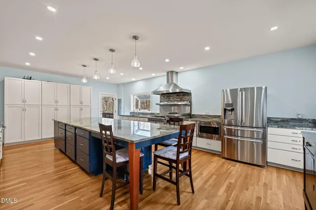 a bathroom with a sink a mirror and vanity