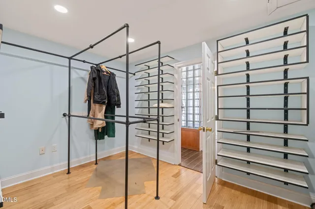 a view of an empty room with wooden floor